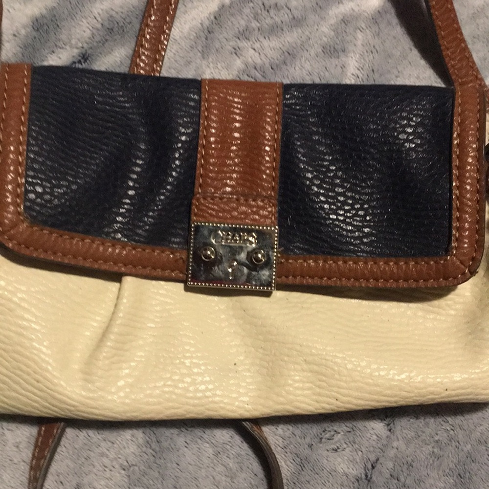 Cute Repost of a Champ cross body purse. Brown,white, and Navy Blue.